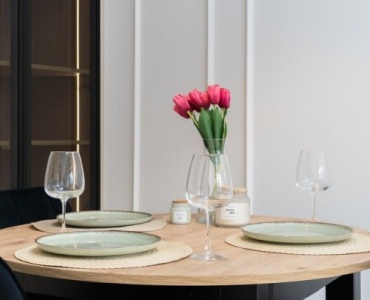 Gather Round: Designing a Stylish Dining Room Around a Round Wooden Table